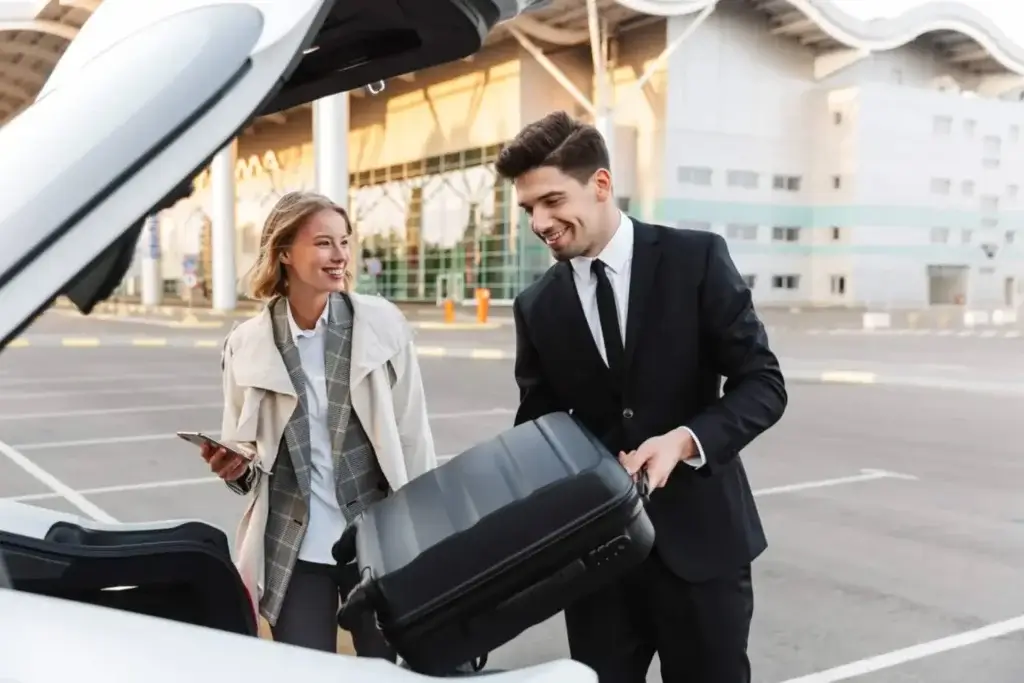 Professional chauffeur loading luggage for a traveler using American Car Service NJ airport transportation.