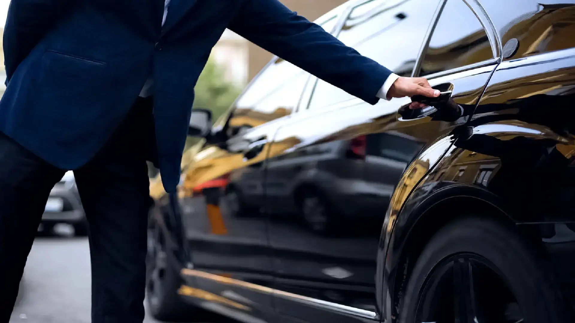 American Car Service NJ Professional chauffeur opening a luxury car door for American Car Service in New Jersey.