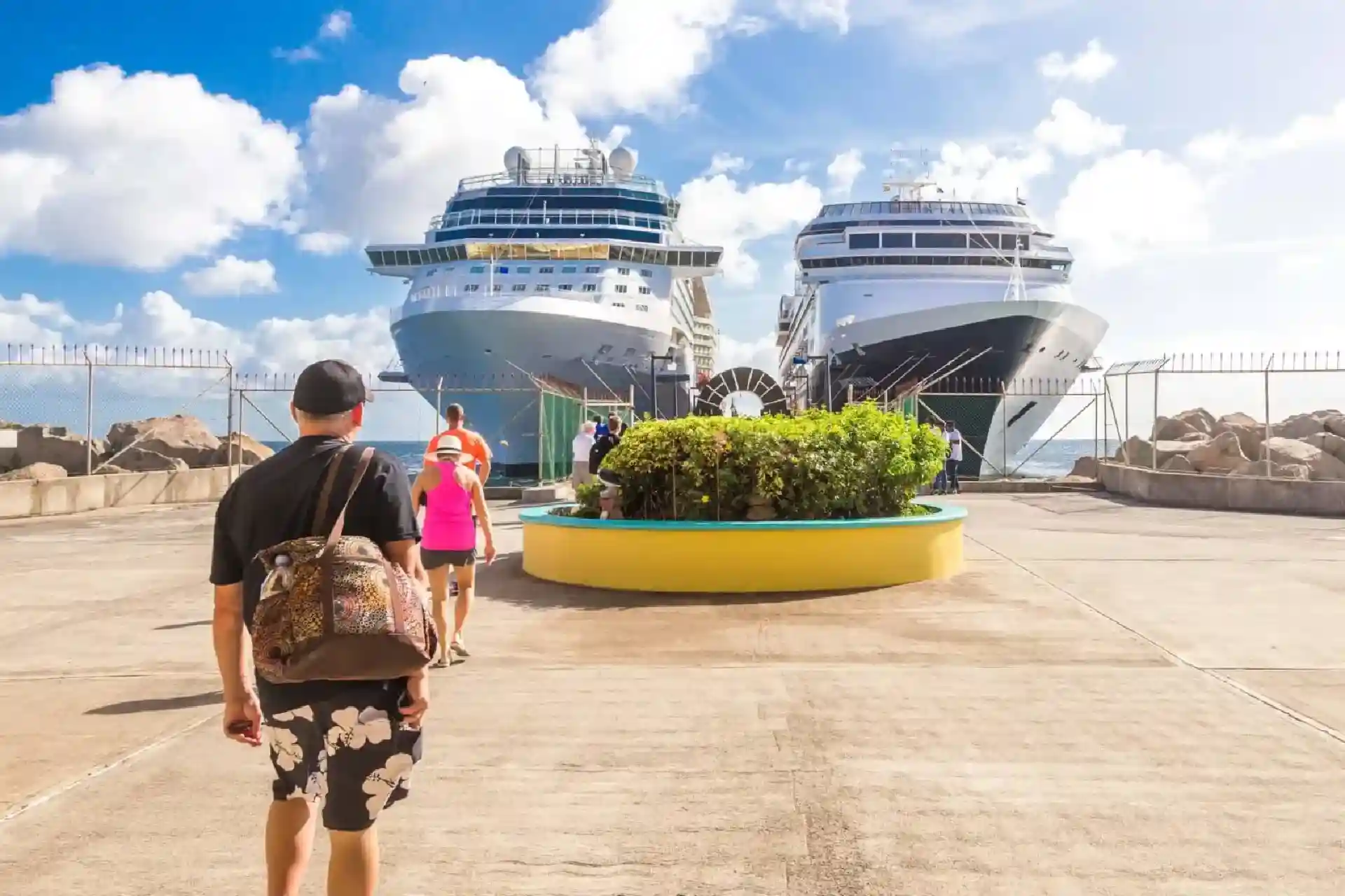 Passengers walking toward cruise ships docked at a sunny pier, representing travel, port transfers, and American car service in New Jersey.
